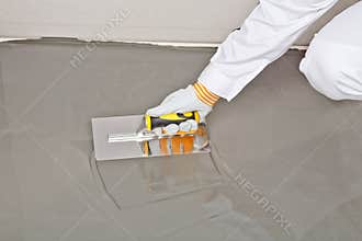 Spreading self leveling compound with trowel