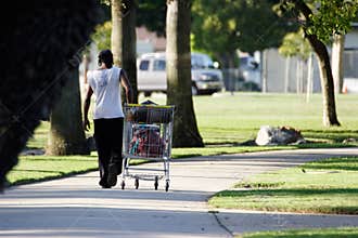 Homeless man with shopping cart