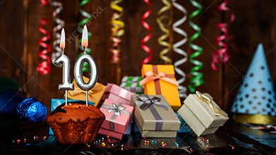 Birthday background with muffin and candles with number 10. Beautiful anniversary background with cake copy space with burning