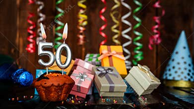 Birthday background with muffin and candles with number 50. Beautiful anniversary background with cake copy space with burning