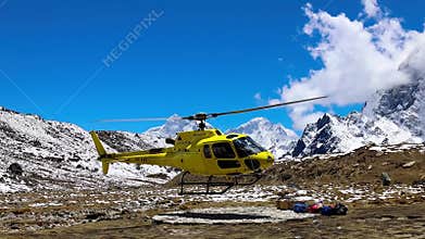 Helicopter landing and taking off from a helipad in Himalaya mountains