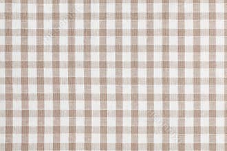 Beige checkered fabric. Tablecloth texture