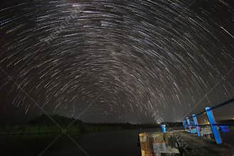 Star trails at a boat dock in the Mentawai Islands