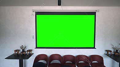 Green projector screen on the wall.