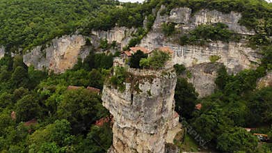 Drone aerial of Katskhi Pillar limestone monolith with Orthodox monastery on top in Chiatura, Georgia. Unique spiritual site of