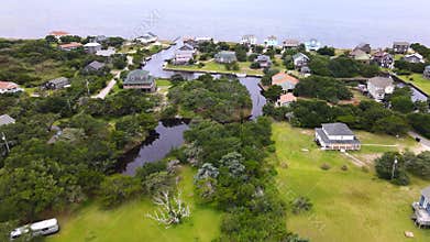 An aerial view of the town of Avon, North Carolina, the houses, canals and roads of the town.