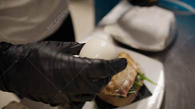 Chef Adding Mozzarella Cheese On Top Of The Grilled Swordfish Burger Dish