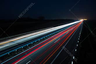 Night highway with car traffic and blurry lights