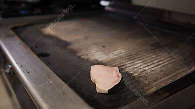 Chef Putting A Slice Of Swordfish On Top Of The Grill