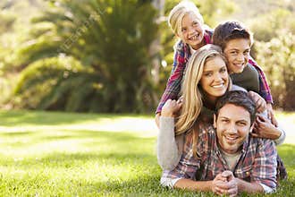 Portrait Of Family Lying On Grass In Countryside