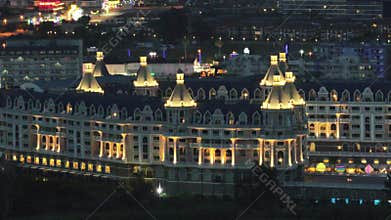 Stunning aerial sunset to night transition over Turkler in Alanya, Turkey. Alanya coastline,resorts,marina,hotels and city lights