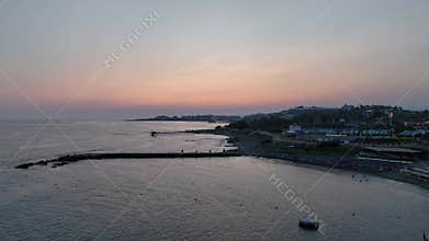 Stunning aerial sunset to night transition over Turkler in Alanya, Turkey. Alanya coastline,resorts,marina,hotels and city lights