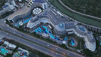 Stunning aerial sunset to night transition over Turkler in Alanya, Turkey. Alanya coastline,resorts,marina,hotels and city lights