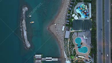 Stunning aerial sunset to night transition over Turkler in Alanya, Turkey. Alanya coastline,resorts,marina,hotels and city lights