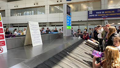 Baggage Claim Chaos at Airport With Long Lines and Anxious Travelers Waiting for Luggage