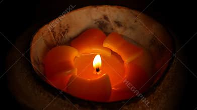 Tropical flower design candle isolated on black background
