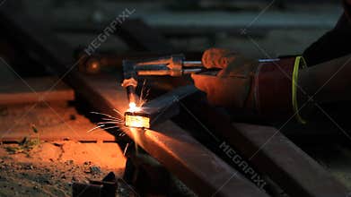 Gas cutting metal using acetylene torch