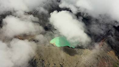Scenic drone view of wisps of volcanic smoke rising from the summit against a dramatic sky