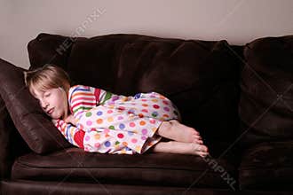 Cozy asleep in pajamas on sofa