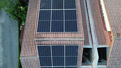 Solar energy with cell panels or PV modules installed on top of house rooftop.