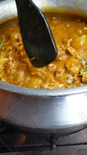 Cooking delicious mutton curry in a traditional pot on the stove