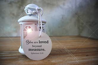 Bible verse quote - You are loved beyond measure. Ephesians 9:13. Religious text on a paper white lantern.