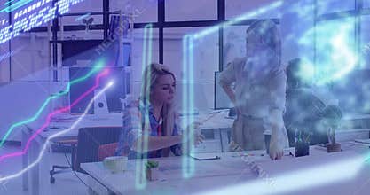 Seated designer pointing prints and colleague highlighting layout with 3D charts during review