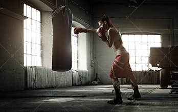 Young woman boxing workout in an old building