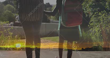 Mother nearing gate walking daughter offering reassurance during technology-themed glitch overlay