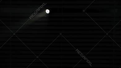 illuminating room, rays of light from flashlight shine through blinds