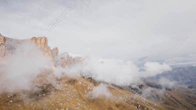 Drone shooting, above panoramic view with high steep rocky mountains, partly cloudy sky, hiking in the Alps, majestic
