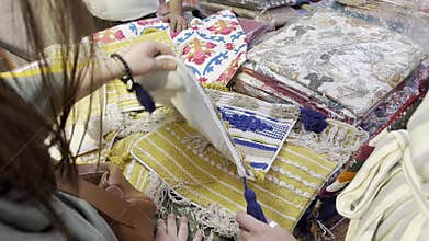 Home textile market in India. Decorative fabrics with embroidery, tassels, floral patterns, and