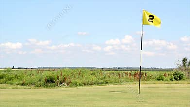 Golf field with yellow flag