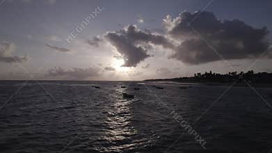 Drone footage of people who are sailing boats at Praia Da Baleia, Itapipoca - CE, Brazil at dawn.