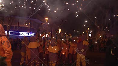 Barcelona, Spain - 20 January 2025: traditional catalan Correfoc, people dressed as devils with firecrackers, in slow motion