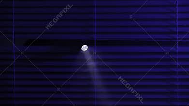 crime and robbery concept, male thief with flashlight looking into help through blinds, close up