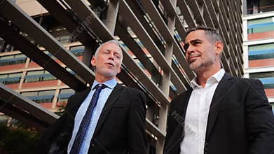 Two Confident Businessmen in a Job Conversation While Walking Together in Stylish Attire, Exuding Professionalism and