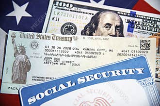 U.S. Treasury check, SSN and American dollar bill with flag in the backdrop, close up. Social Security card and treasurey check
