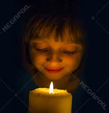 Happy little girl with a candle