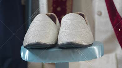 Pair of white embroidered wedding shoes
