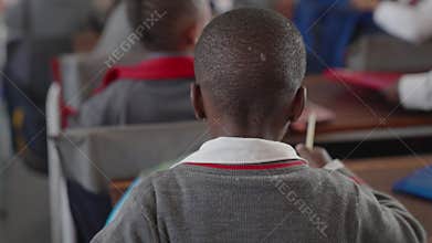 Backshot of the students sitting in the class room at the school in Johannesburg, South Africa