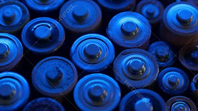 Rotating close-up view of depleted batteries illuminated by blue light