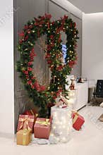 Chrismast decoration details with green leafy plants, gift boxes, owl and reindeer toy