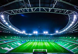 Modern Football Stadium with Dramatic Spotlighting at Night, Competition and Championship Concepts