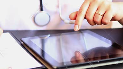 Doctor working on digital tablet computer