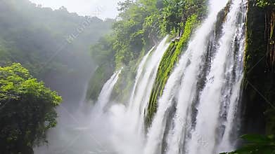 Misty Waterfall Cascades Through Lush Jungle