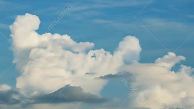 The sky is filled with clouds, and the clouds are white and fluffy