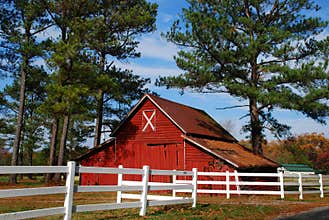 Red barn and white fence