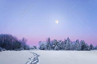 Evening winter landscape with full moon