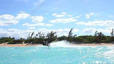 Man Kite Boarding In Ocean Doing Trick Above Camera